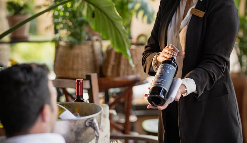 Botegga Cava di Vino personalized wine service and gourmet charcuterie platter in a garden setting at Grecotel LUXME Costa Botanica by Kenwood Travel