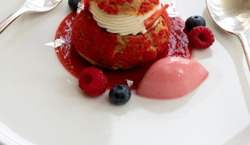 Botanica Fine Dining A beautifully plated gourmet seafood carpaccio dish garnished with caper berries, microgreens, and delicate sauces at Grecotel LUXME Costa Botanica by Kenwood Travel