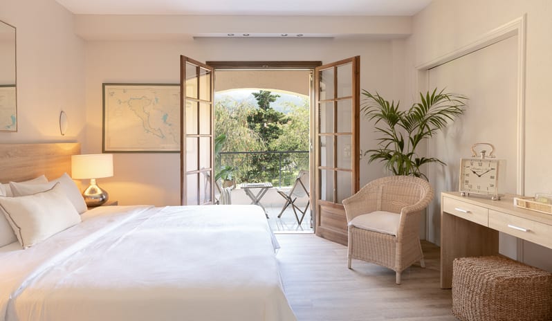 Family Apartment Veranda & Gardens Luxury resort family suite bedroom with a balcony and garden view. at Grecotel LUXME Costa Botanica by Kenwood Travel