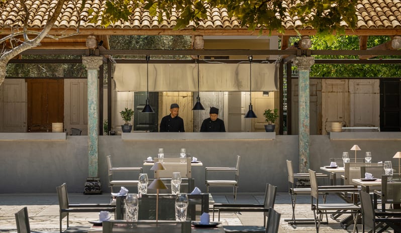 Asiana Two professional chefs working at the modern open-air kitchen counter of Asiana Restaurant at Grecotel LUXME Costa Botanica by Kenwood Travel