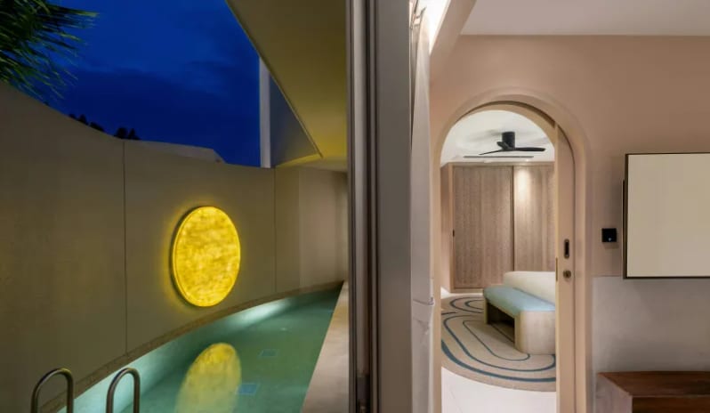 One Bedroom Pool Villa Evening view of a luxury one-bedroom pool villa, showcasing an illuminated private plunge pool with a glowing yellow circular wall light and a view into the bedroom suite at Centara Karon Villas Phuket by Kenwood Travel