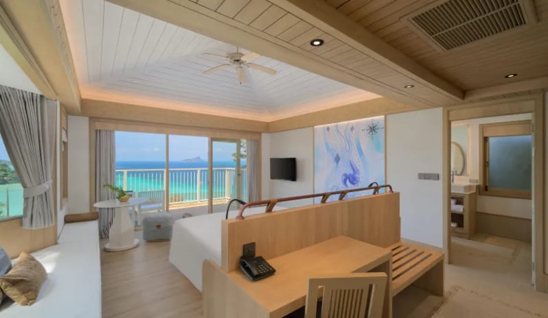 Villa Ocean ViewVilla bedroom suite with wooden desk, en-suite bathroom access, and ocean view at Centara Villas Phi Phi Island by Kenwood Travel