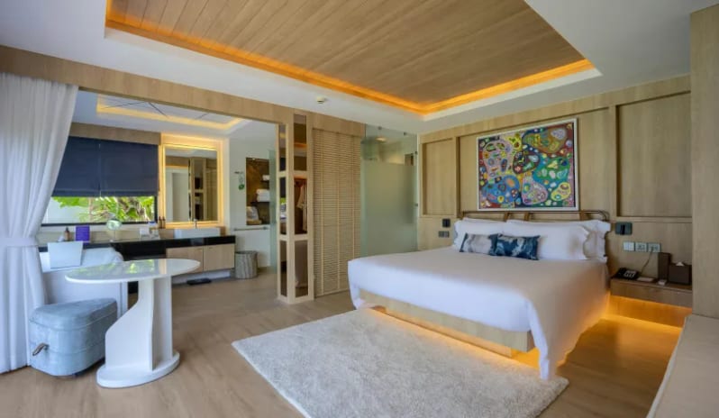 Duplex Suite Spa Ocean View Modern luxury duplex suite bedroom with king bed, wooden accents, and attached spa bathroom at Centara Villas Phi Phi Island by Kenwood Travel