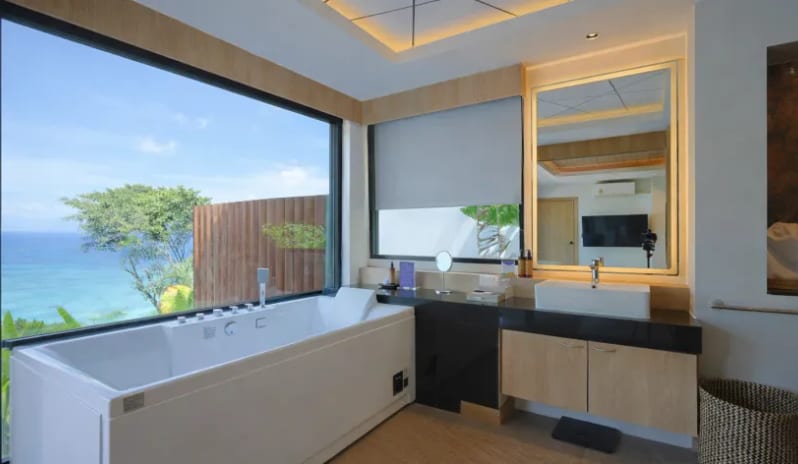 Duplex Suite Spa Ocean View Duplex suite luxury bathroom with jacuzzi tub and ocean view window at Centara Villas Phi Phi Island by Kenwood Travel