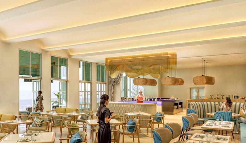 Talee Bar Contemporary restaurant interior design showcasing recessed warm ceiling lighting, woven pendant lights, and blue and gold coastal decor at Centara Villas Phi Phi Island by Kenwood Travel
