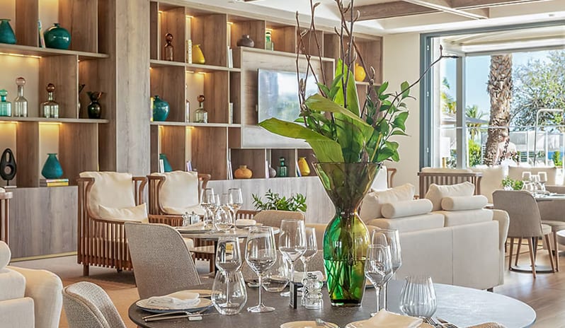 Peseta Restaurant boho-chic decor, greenery-wrapped pillars, and elegant wooden furniture at Paradisus Gran Canaria by Kenwood Travel