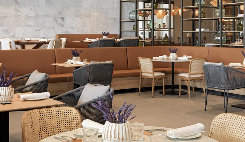 MasCalzone - Trattoria Modern restaurant dining room featuring marble tables, rattan chairs, and lavender centerpieces at Paradisus Gran Canaria by Kenwood Travel