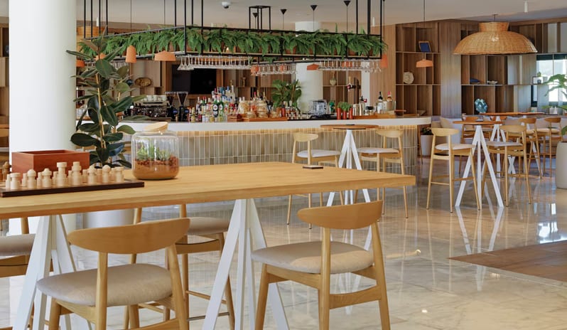 Ginger Grand Café & Lobby Bar odern open-plan hotel bar and lounge featuring light wood furniture, marble floors, and a hanging planter above the bar at Paradisus Gran Canaria by Kenwood Travel