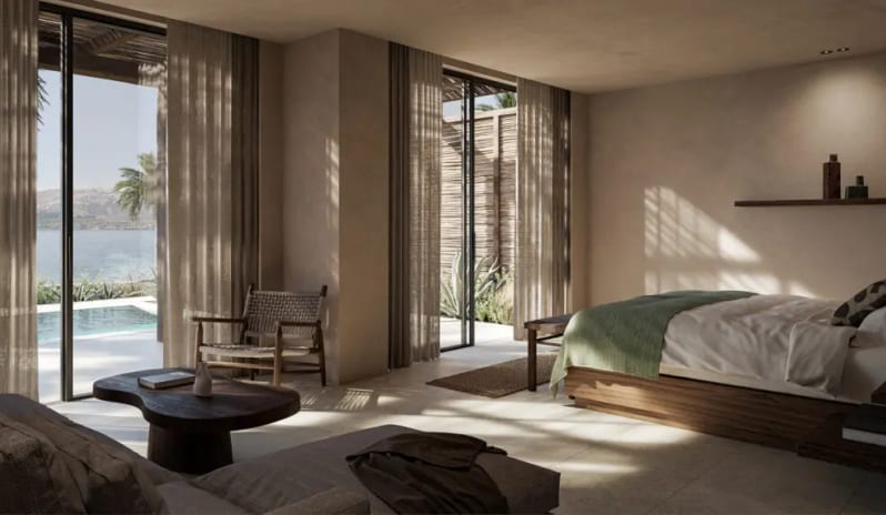 Deluxe Suite with Private Pool Modern minimalist bedroom with floor-to-ceiling windows overlooking a private pool and the ocean, featuring neutral tones and organic wood furniture at the foot at OKU Bodrum by Kenwood Travel