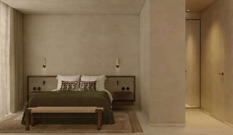 Junior Suite Modern minimalist bedroom with olive green bedding, textured beige walls, and contemporary wall sconces at OKU Bodrum by Kenwood Travel