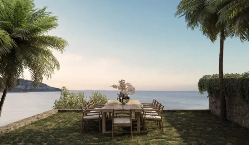 Teyo Modern wooden outdoor dining set with eight chairs arranged on a lawn facing a scenic sea view at OKU Bodrum by Kenwood Travel