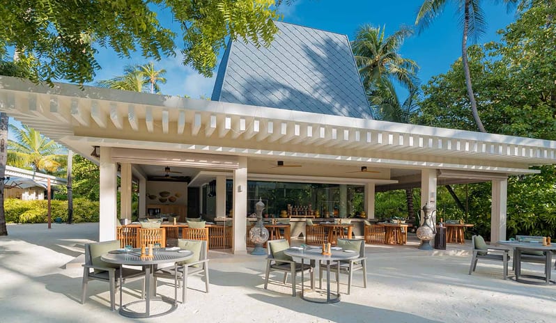 Spice Atmosphere Kanifushi Maldives featuring open-air beachfront seating and contemporary island architecture at Kuda Villingili Resort Maldives by Kenwood Travel