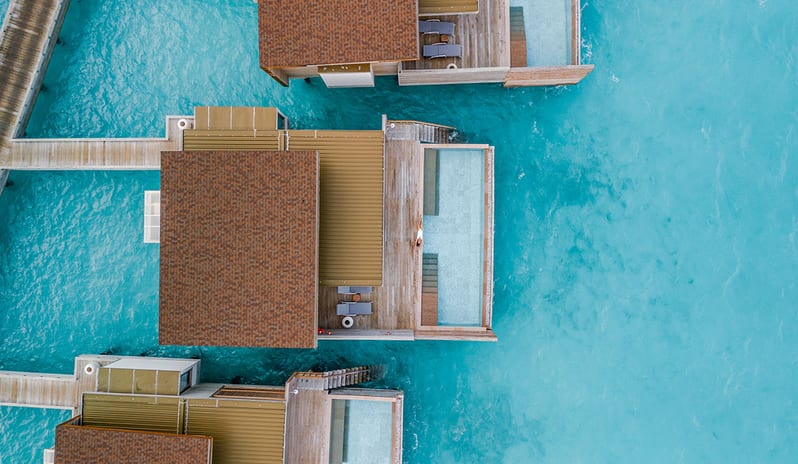 Sunrise Water Villa with Private Pool private plunge pools and direct ocean access, surrounded by vibrant azure sea water at Kuda Villingili Resort Maldives by Kenwood Travel