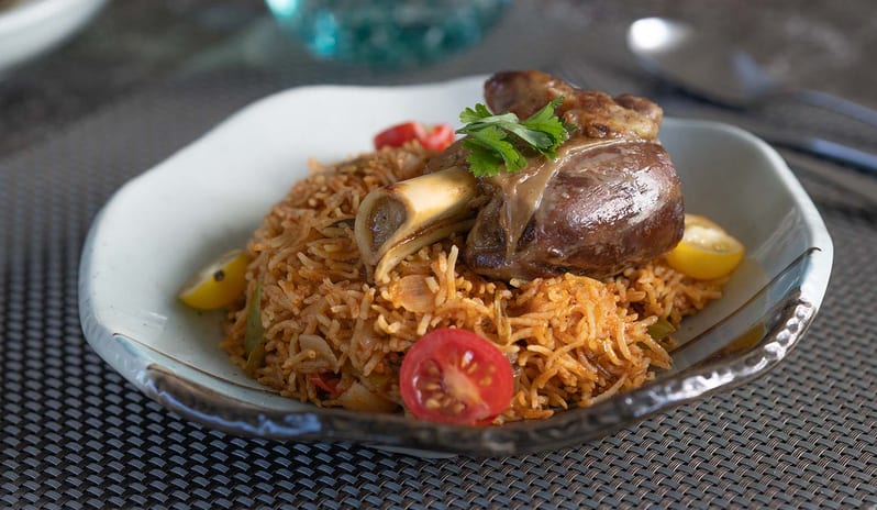 Spice Slow-cooked lamb shank served over aromatic basmati rice biryani at The Spice restaurant in Atmosphere Kanifushi Maldives at Kuda Villingili Resort Maldives by Kenwood Travel