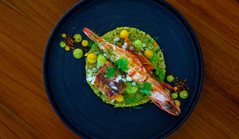 Mar-Umi Masterfully plated seafood entree on a matte black plate, showcasing fresh ingredients and contemporary fine-dining presentation at Kuda Villingili Resort Maldives by Kenwood Travel