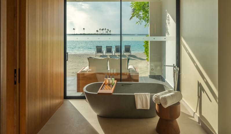 Two Bedroom Beach Villa with Private Pool Modern freestanding soaking tub in a beach villa with direct ocean views at Kuda Villingili Resort Maldives by Kenwood Travel