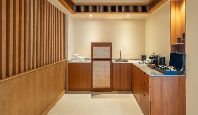Three bedroom Beach Residence with Private Pool vertical wood paneling, a small sink, and a coffee station with a curated selection of amenities at Kuda Villingili Resort Maldives by Kenwood Travel