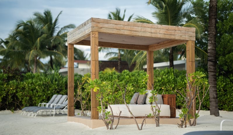 Two Bedroom Beach Villa with Private Pool Wooden beach cabana and sun loungers on a private tropical beach at Kuda Villingili Resort Maldives by Kenwood Travel