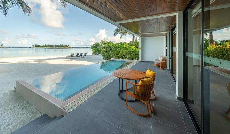 Two Bedroom Beach Villa with Private Pool Beachfront villa terrace with private pool and ocean views under a modern wooden ceiling canopy at Kuda Villingili Resort Maldives by Kenwood Travel