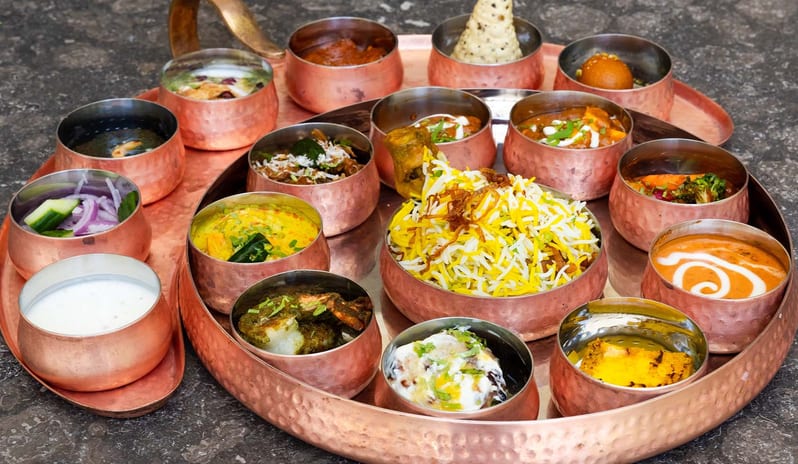 Spice biryani, curries, and traditional side dishes at Atmosphere Kanifushi Maldives at Kuda Villingili Resort Maldives by Kenwood Travel