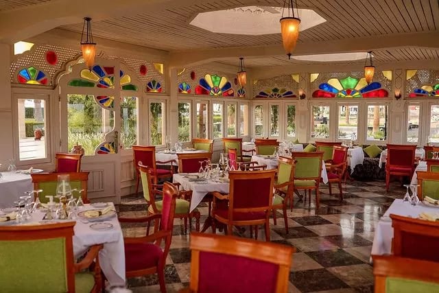Taj Mahal Restaurant checkered floors, stained glass windows, and tables set with white tablecloths at Baron Resort Sharm El Sheikh by Kenwood Travel