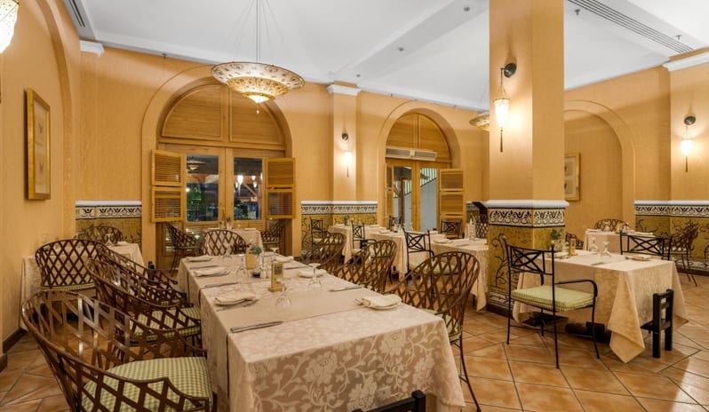 Rosmarino spacious hotel dining hall beautifully arranged for dinner service with neatly set tables, tiled flooring, and pillars at Royal Savoy Sharm El Sheikh by Kenwood Travel