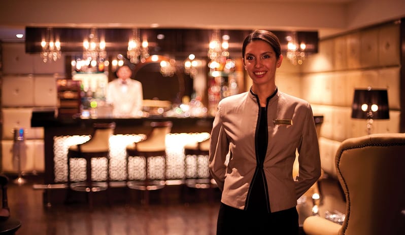 The Niche Bar professional hostess in a sleek uniform welcoming guests at Baron Resort Sharm El Sheikh by Kenwood Travel