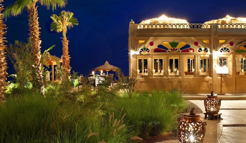 Taj Mahal Restaurant illuminated traditional domes, colorful stained glass windows, and an outdoor beachside patio at Baron Resort Sharm El Sheikh by Kenwood Travel