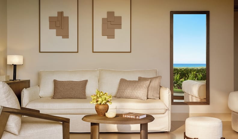 Double Room Ground Floor Sea View living room featuring a cream-colored sofa with neutral brown throw pillows, a round wooden coffee table with a floral arrangement, and minimalist framed wall artat Sani Club by Kenwood Travel