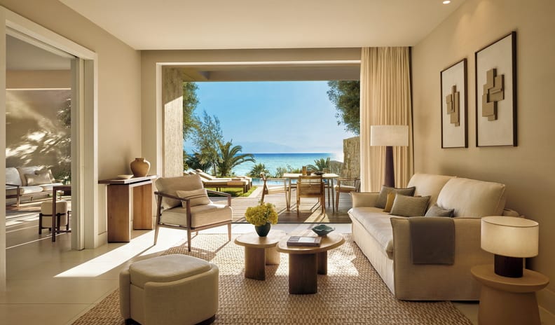 One Bedroom Bungalow Suite Private Pool Sea View Luxury resort suite living room opening onto a private wooden deck with an outdoor dining area and ocean view at Sani Club by Kenwood Travel