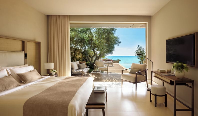 Two Bedroom Bungalow Suite PrIvate Pool Beach Front Luxury hotel suite with a king bed, modern interior design, and an open terrace overlooking a private pool and the ocean at Sani Club by Kenwood Travel