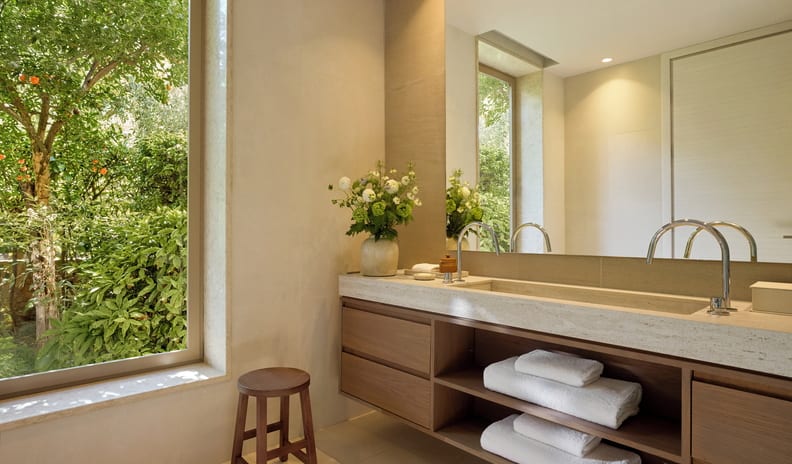 Two Bedroom Bungalow Suite Private Pool Front Sea ViewElegant boutique hotel bathroom suite with a double faucet wooden vanity and scenic garden view at Sani Club by Kenwood Travel