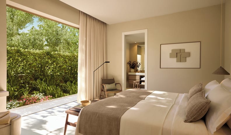 Two Bedroom Bungalow Suite Private Pool Front Sea Viewtwin beds with earthy-toned throws, neutral wall art, an armchair, and views of a sunlit, private garden terrace at Sani Club by Kenwood Travel