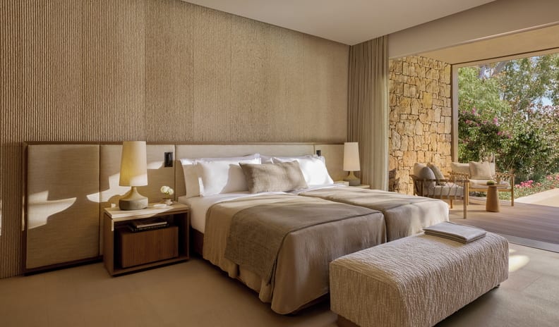 Three Bedroom Villa Pr. Pool Garden View bedroom with twin beds, warm ambient lighting, elegant neutral decor, and a private outdoor terrace overlooking a garden at Sani Asterias by Kenwood Travel