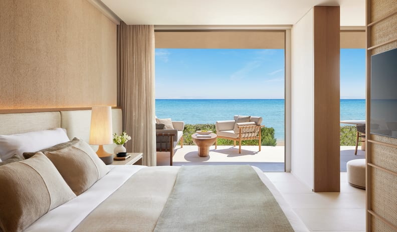 One Bedroom Residence Private Garden Beach Front SV minimalist neutral decor opening up to a private patio with ocean views at Sani Asterias by Kenwood Travel