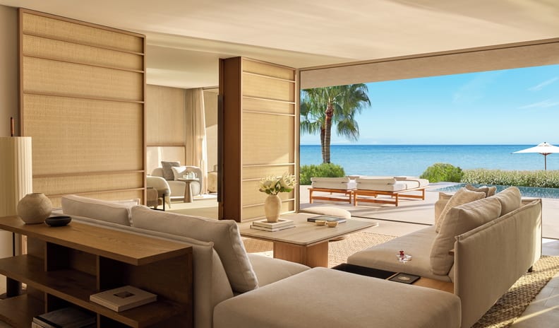 Two Bedroom Residence Pr. Pool Beach Front SV coastal living room interior featuring Japandi-style woven sliding walls, a wooden console shelf, and seamless patio integration at Sani Asterias by Kenwood Travel