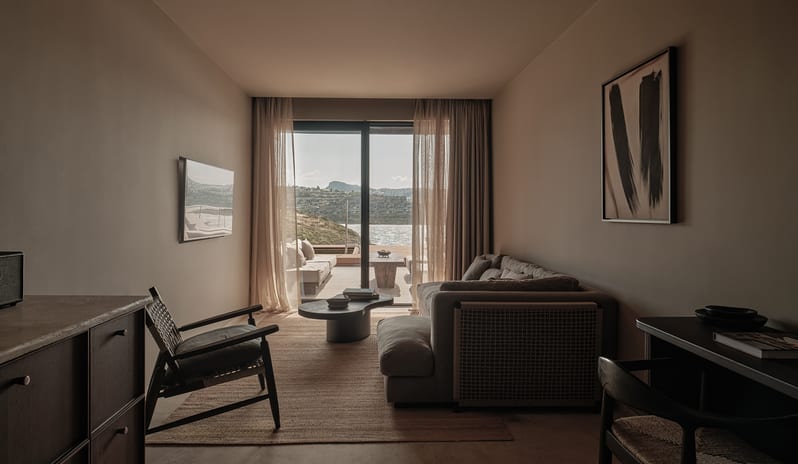 Two Bedroom Suite with Private Pool iplush sectional sofa, minimalist wooden furniture, and floor-to-ceiling glass doors opening onto a private terrace with sea views at OKU Bodrum by Kenwood Travel