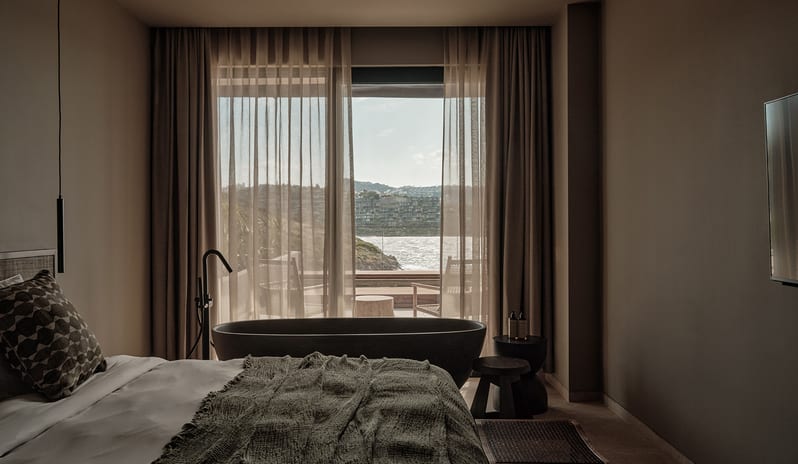 Two Bedroom Suite with Private Pool in-room freestanding bathtub, textured green bedding, and a private terrace overlooking the sea at OKU Bodrum by Kenwood Travel