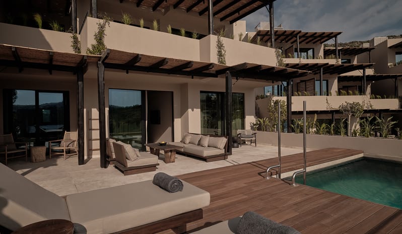 Two Bedroom Suite with Private Pool exterior architecture with earthy textured walls, natural timber pergolas, private pools, and minimalist outdoor furniture at OKU Bodrum by Kenwood Travel