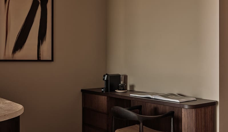 Deluxe Suite with Private Pool In-room workspace and espresso station in a boutique hotel room with warm earthy tones at OKU Bodrum by Kenwood Travel