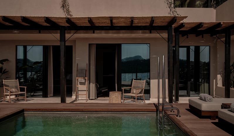 Deluxe Suite with Private Pool Modern minimalist resort exterior with a private swimming pool, wooden pergola, and outdoor lounge chairs at OKU Bodrum by Kenwood Travel