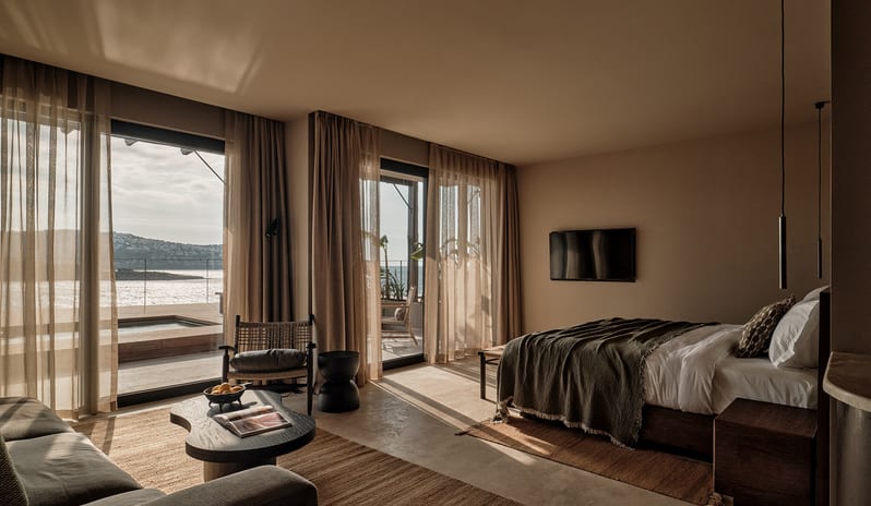 Deluxe Suite with Private Pool beachfront hotel suite with warm earthy tones, integrated living space, and an outdoor patio overlooking the sea at OKU Bodrum by Kenwood Travel