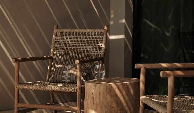 Junior Suite Minimalist outdoor wooden chairs and a log side table on a luxury hotel balcony at OKU Bodrum by Kenwood Travel