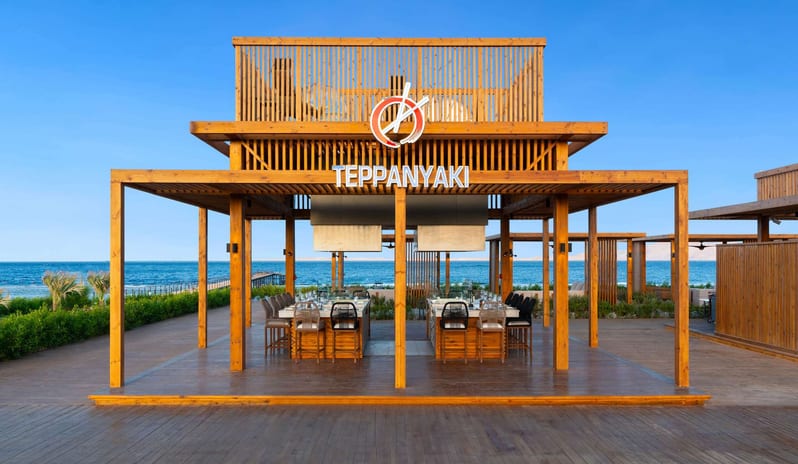 Teppanyaki Beachfront outdoor Teppanyaki restaurant pavilion with a wooden deck and sea views at Rixos Radamis Sharm El Sheikh by Kenwood Travel