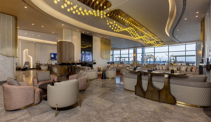 Executive Lounge Luxury hotel executive lounge interior featuring elegant sofa seating, striking gold ceiling installations, and large windows at Rixos Radamis Sharm El Sheikh by Kenwood Travel