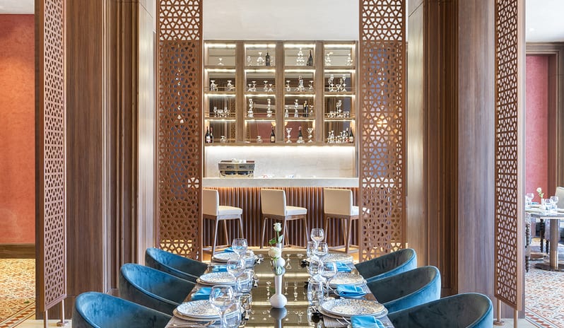 Lalezar Teal velvet seating and table setting framed by geometric screens looking toward the bar at Rixos Radamis Sharm El Sheikh by Kenwood Travel