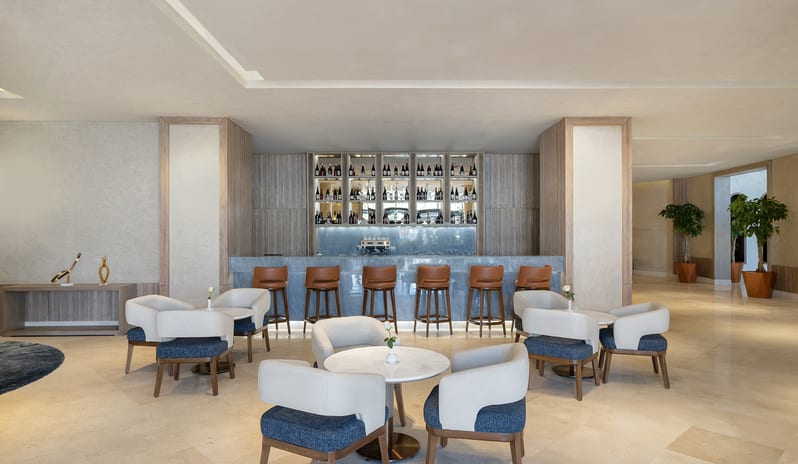 Lobby Bar Elegant resort lobby bar featuring a blue marble-topped counter, cognac leather bar stools, and comfortable café table seating at Rixos Radamis Sharm El Sheikh by Kenwood Travel
