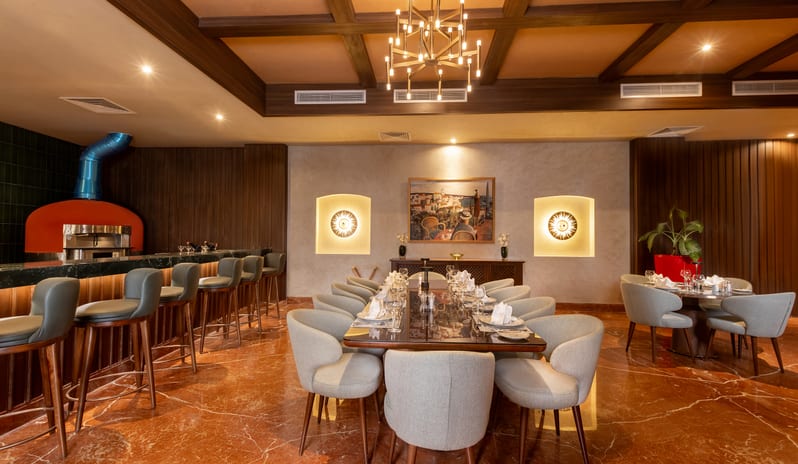 L'Olivio large dining table and an open kitchen pizza oven at Rixos Radamis Sharm El Sheikh by Kenwood Travel