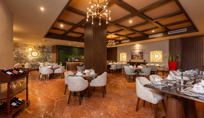 L'Olivio large dining table and an open kitchen pizza oven at Rixos Radamis Sharm El Sheikh by Kenwood Travel