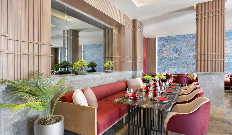 Mandarin Luxury booth seating arrangement and elegant table setting with Asian-inspired decor at Rixos Radamis Sharm El Sheikh by Kenwood Travel